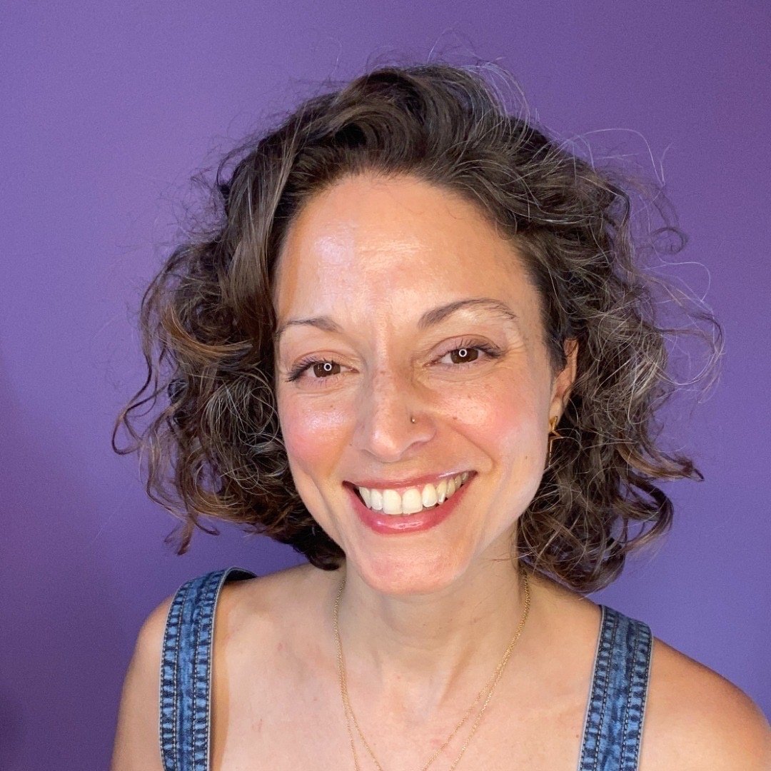 Mary Lou Berkhardt in a denim top in front of a purple background