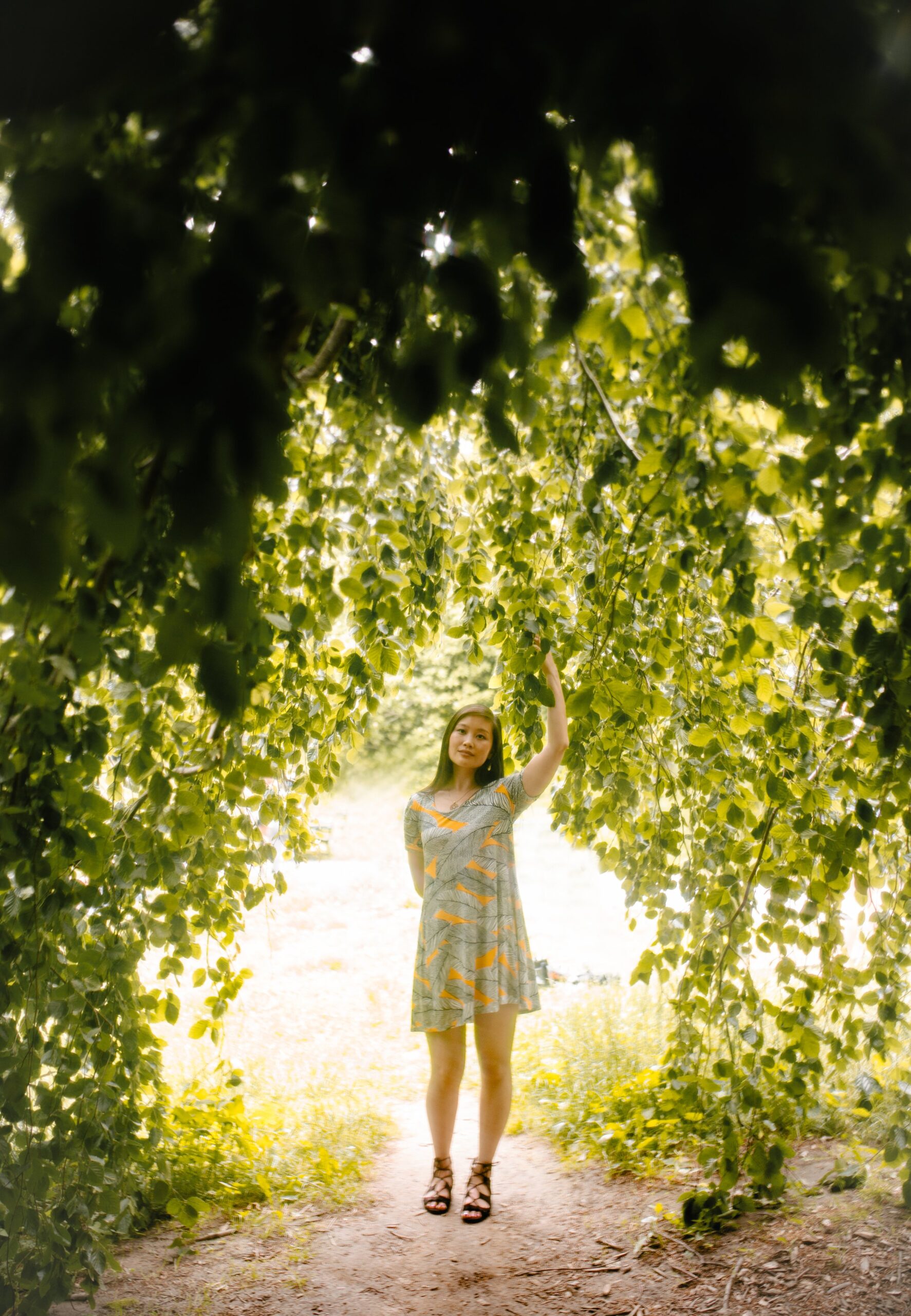 Jessica Hwang standing in an opening of a willow tree