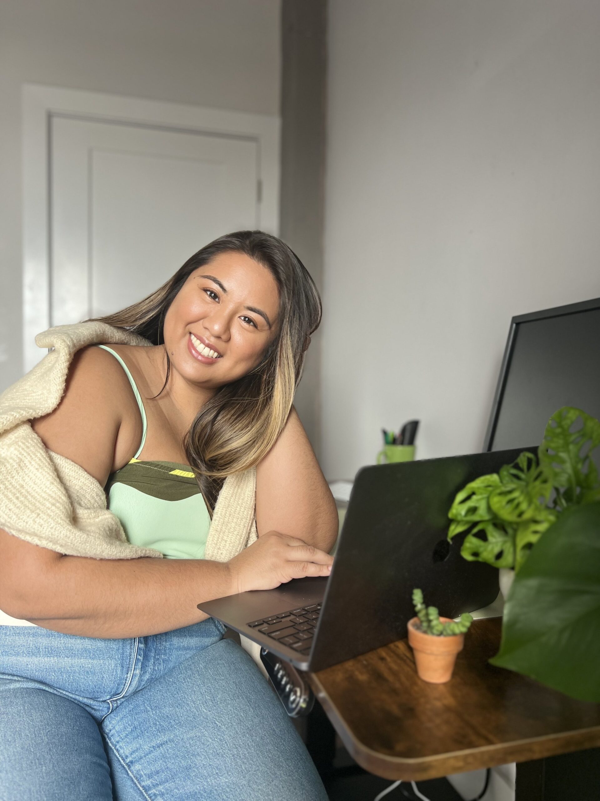 Self-Love Coach Patricia Dayleg sitting at her desk, working on her laptop