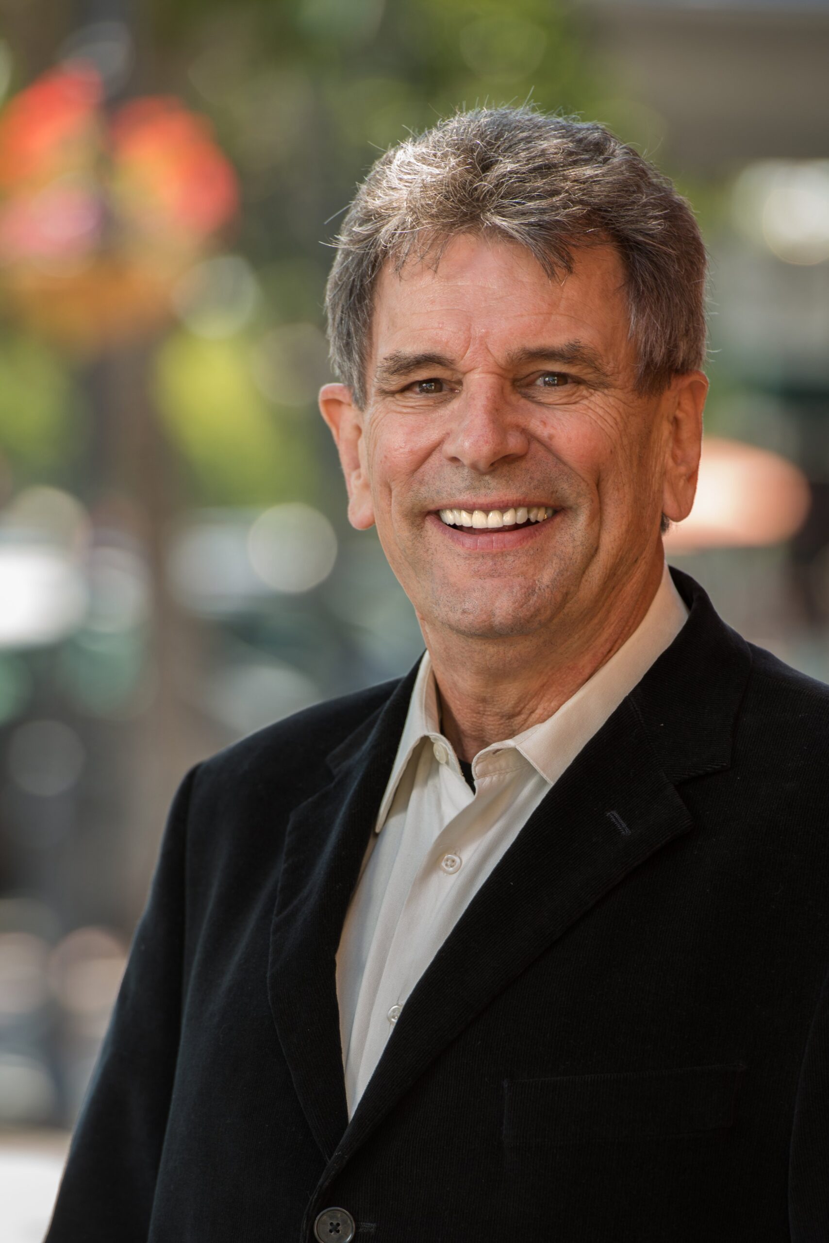 Don Joseph Goewey smiling, wearing a suit jacket.